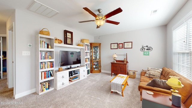 carpeted living room with ceiling fan