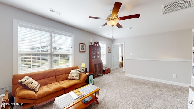 living room featuring light carpet and ceiling fan