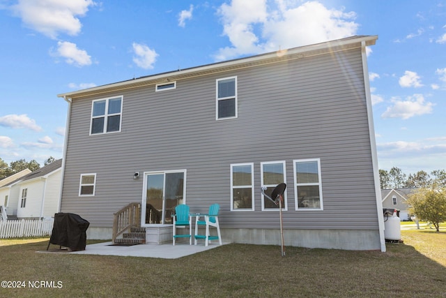 rear view of property with a yard and a patio