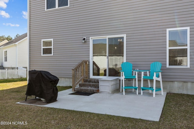 rear view of property featuring a yard and a patio