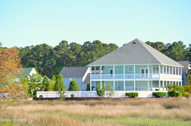 back of house featuring a balcony