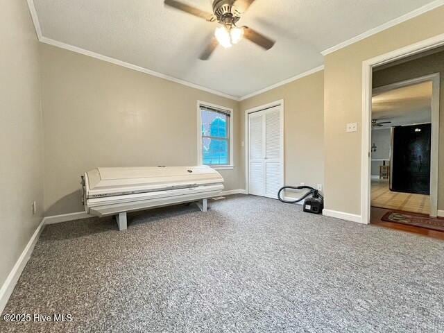 bedroom featuring ceiling fan, carpet floors, crown molding, and a closet