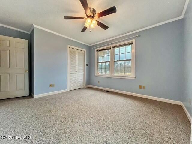 unfurnished bedroom with a closet, ceiling fan, and crown molding