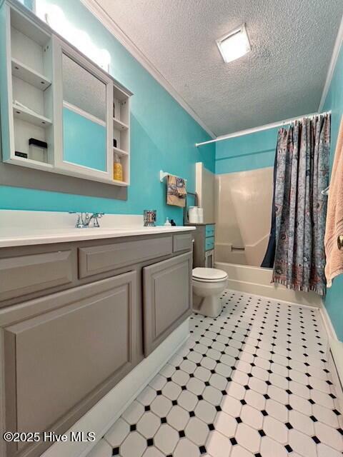 full bathroom with shower / bath combo, toilet, a textured ceiling, and vanity