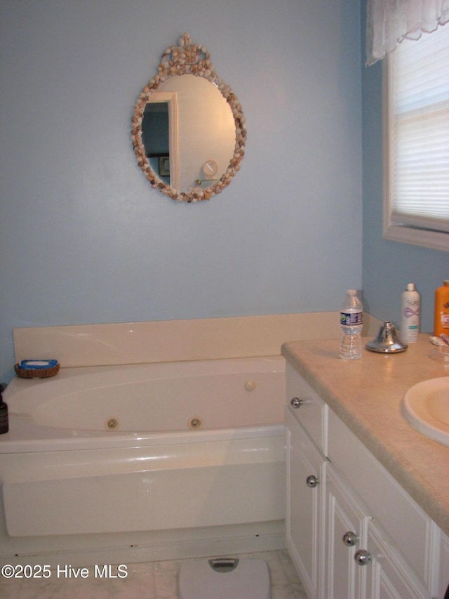 bathroom featuring a washtub and vanity