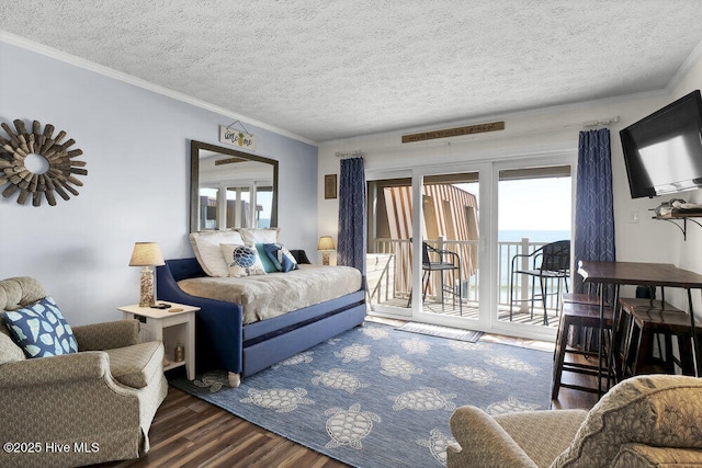 bedroom featuring access to outside, crown molding, and a textured ceiling