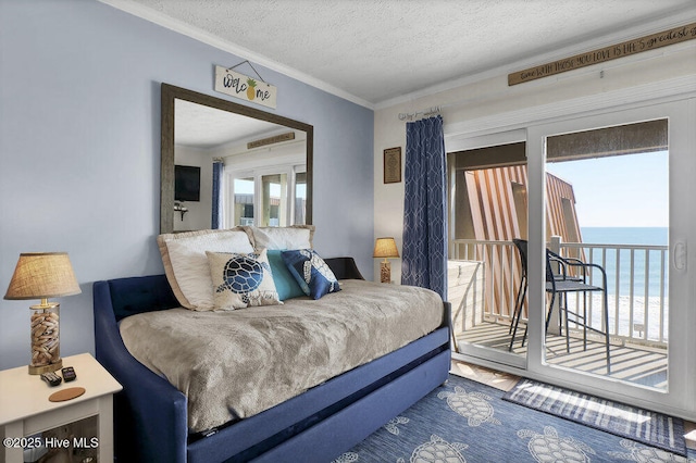 bedroom with access to exterior, a textured ceiling, and ornamental molding