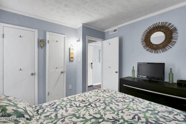 bedroom featuring crown molding and a textured ceiling