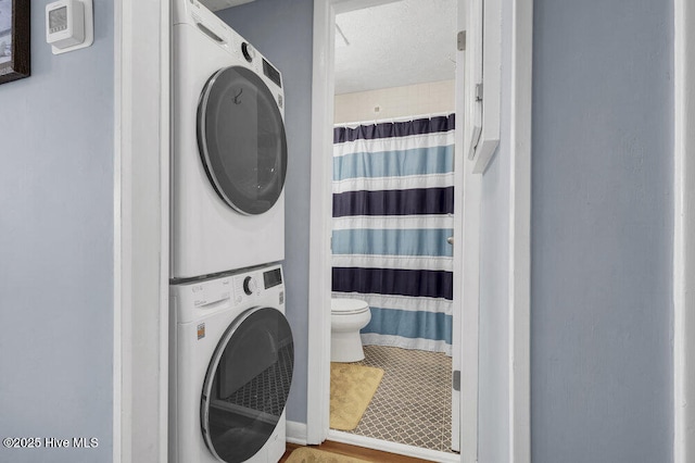 laundry room featuring stacked washer and clothes dryer