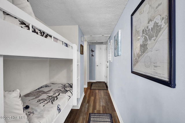 bedroom featuring a textured ceiling and hardwood / wood-style flooring