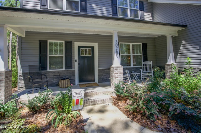 view of exterior entry featuring a porch