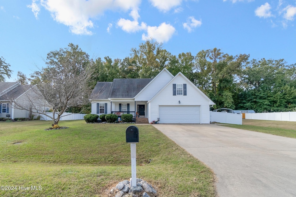 view of front of property with a garage, covered porch, and a front yard