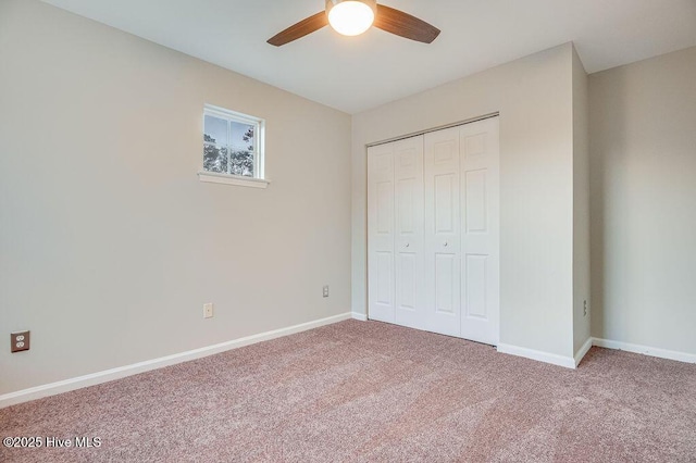 unfurnished bedroom featuring carpet flooring, ceiling fan, and a closet