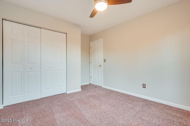 unfurnished bedroom featuring carpet, ceiling fan, and a closet