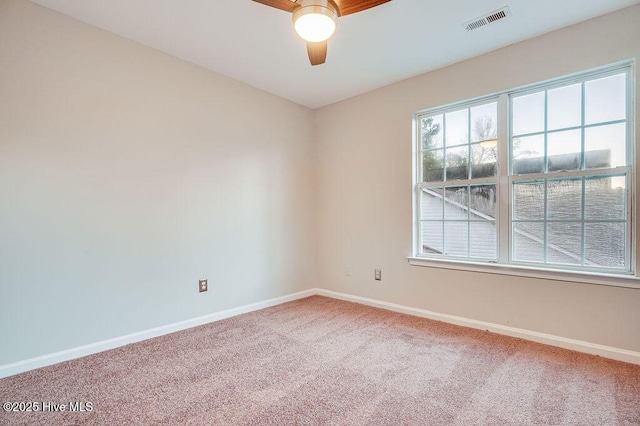 carpeted spare room with ceiling fan