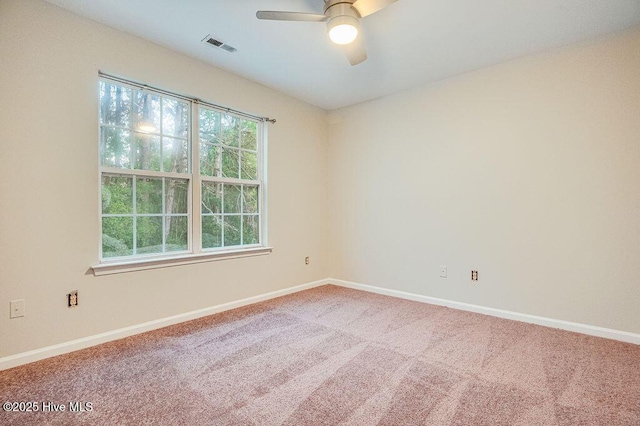 carpeted empty room featuring ceiling fan