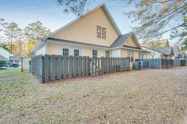 rear view of property featuring central AC