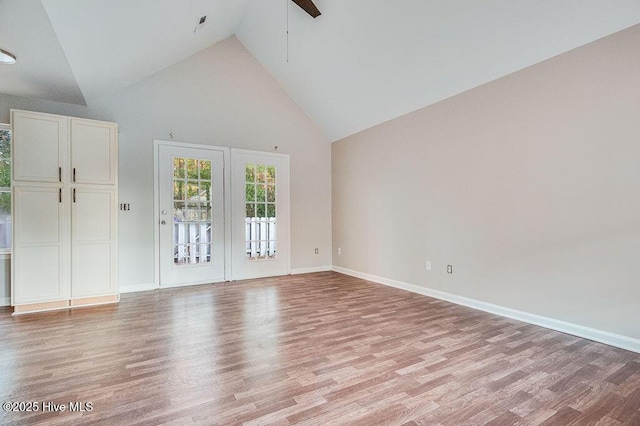 unfurnished room featuring ceiling fan, light wood-type flooring, and high vaulted ceiling