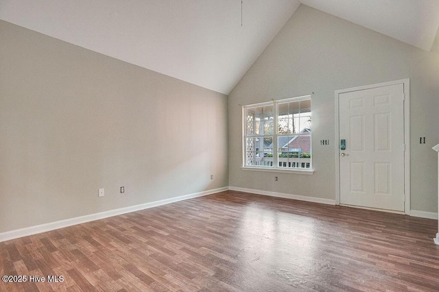 interior space with hardwood / wood-style flooring and high vaulted ceiling