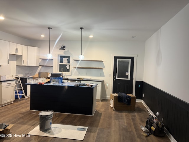 kitchen with a kitchen island, pendant lighting, and white cabinets