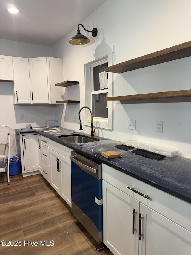 kitchen featuring dark hardwood / wood-style floors, white cabinetry, dishwasher, sink, and dark stone counters