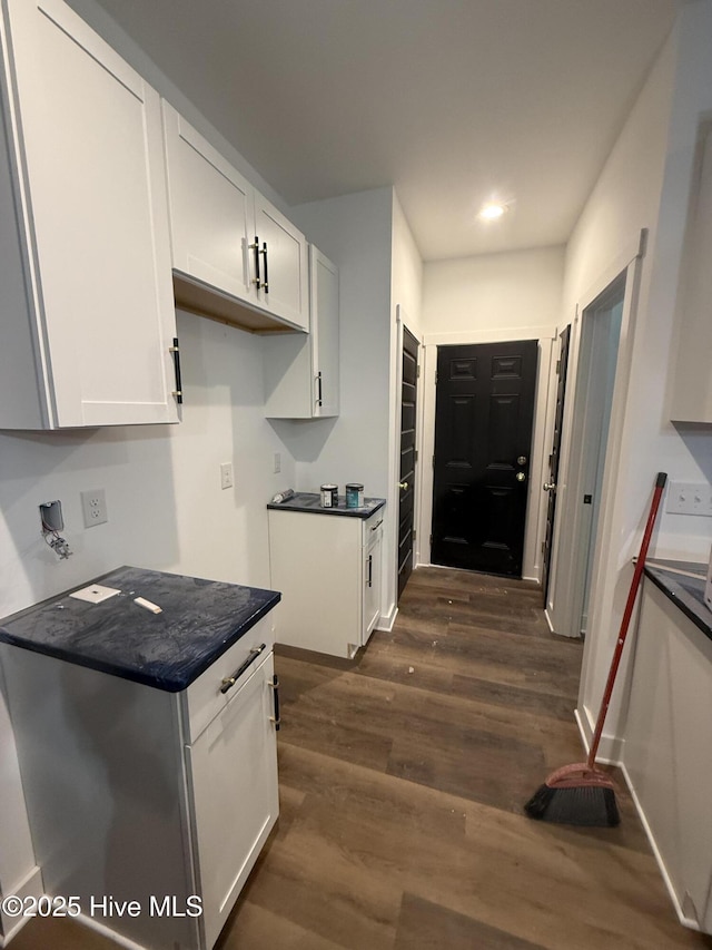 kitchen with dark hardwood / wood-style floors and white cabinets