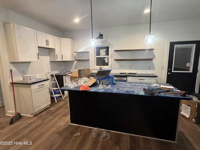 kitchen featuring hanging light fixtures, a center island, and white cabinets