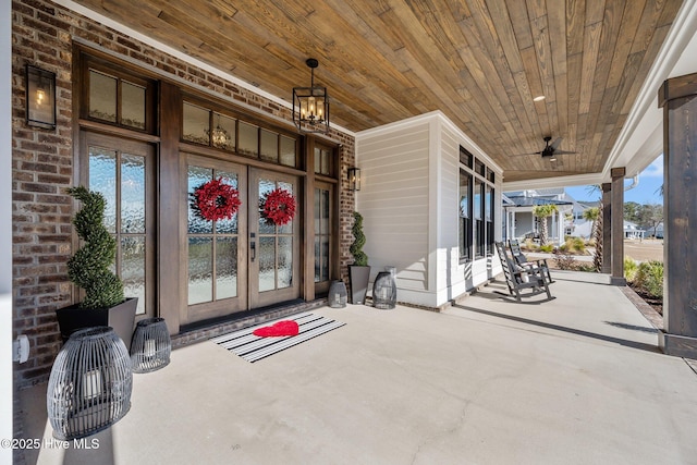 entrance to property with covered porch and french doors