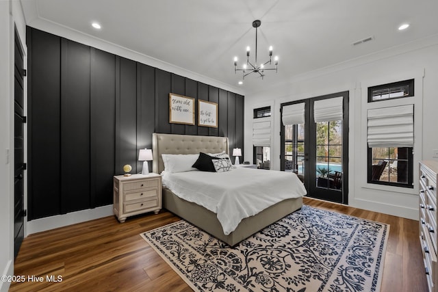 bedroom with dark hardwood / wood-style floors, access to exterior, and crown molding