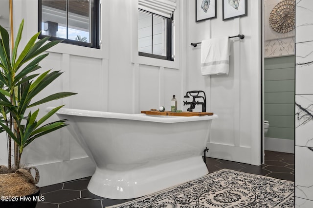 bathroom featuring tile patterned floors and a tub