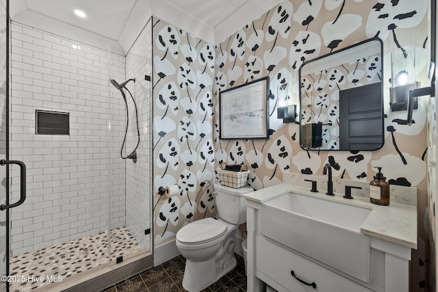 bathroom with tile patterned floors, vanity, toilet, and a shower with door