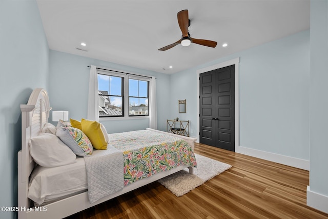 bedroom with hardwood / wood-style floors and ceiling fan