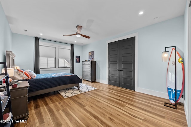 bedroom with ceiling fan and light hardwood / wood-style floors