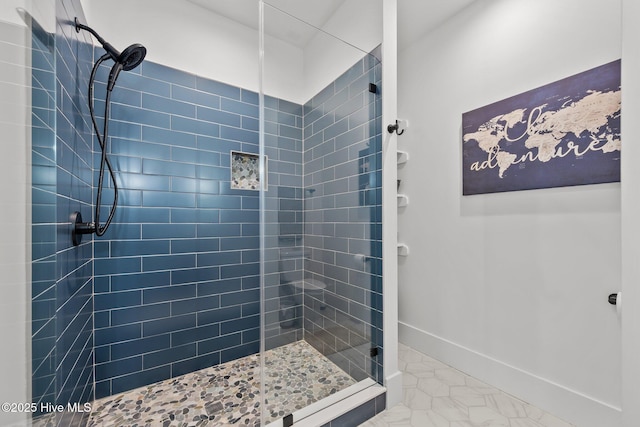 bathroom with tile patterned flooring and tiled shower