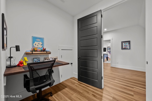 office space with hardwood / wood-style flooring and lofted ceiling