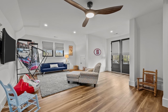 living room featuring ceiling fan and wood-type flooring