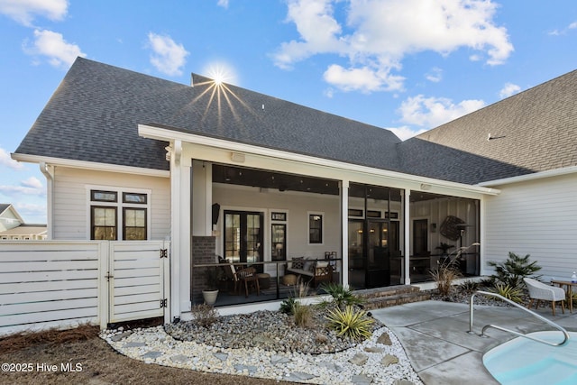 rear view of property featuring a sunroom and a patio