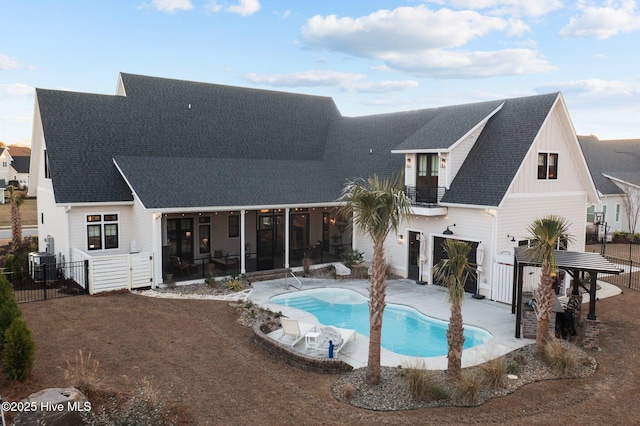 rear view of property with a fenced in pool, a sunroom, central AC unit, and a garage