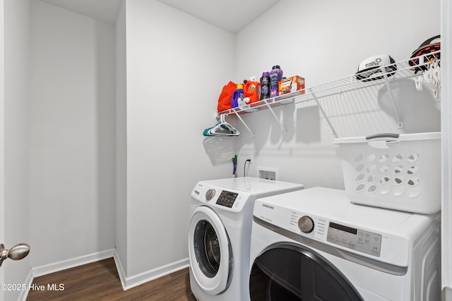 laundry room featuring dark hardwood / wood-style flooring and washing machine and dryer