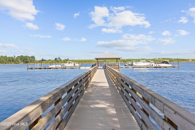 view of dock with a gazebo and a water view