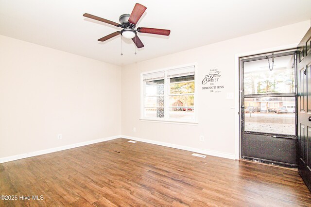 unfurnished room with ceiling fan, a healthy amount of sunlight, and wood-type flooring