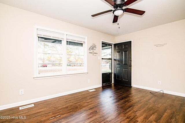 spare room with ceiling fan and dark hardwood / wood-style flooring