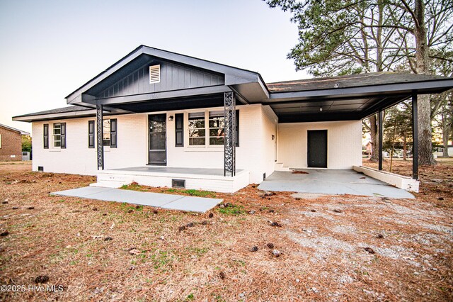 view of front facade featuring covered porch and a carport