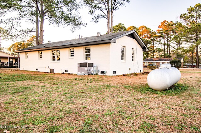 view of side of property with a lawn