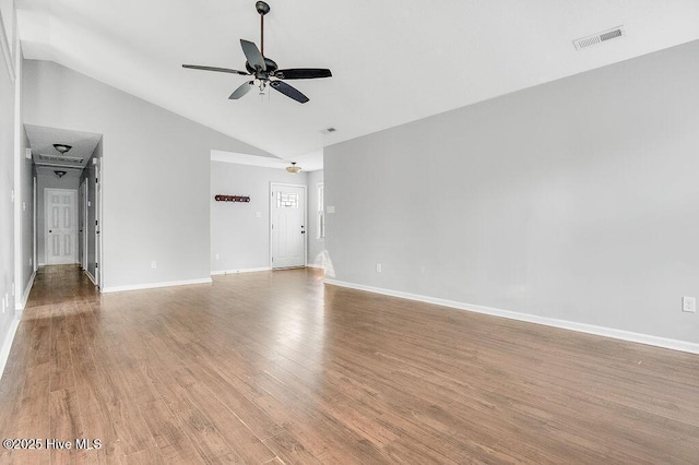 empty room with ceiling fan, high vaulted ceiling, and light wood-type flooring