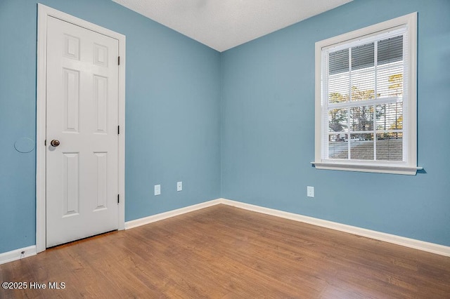 spare room featuring hardwood / wood-style floors