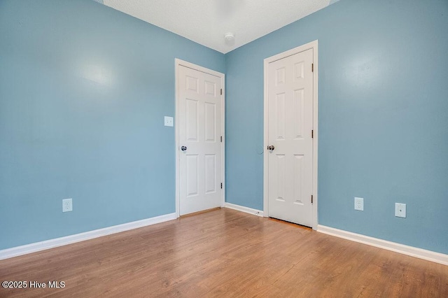 unfurnished room featuring hardwood / wood-style flooring