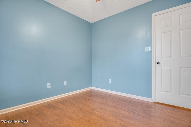 empty room with light hardwood / wood-style flooring