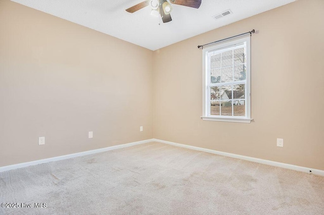 carpeted spare room with ceiling fan