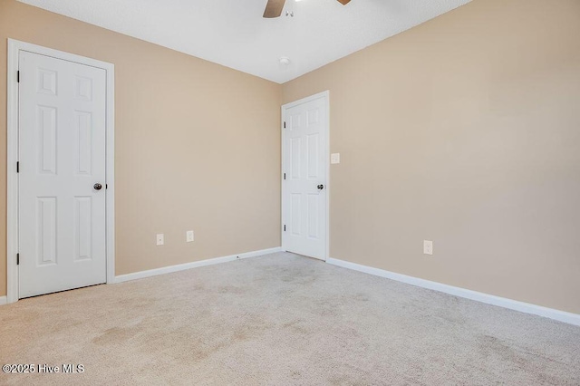 unfurnished room featuring light carpet and ceiling fan